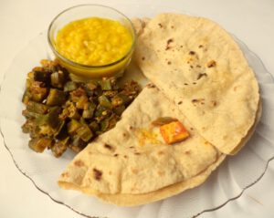 A_thali_with_daal_roti_bhindi_ki_sabzi_and_mango_pickle